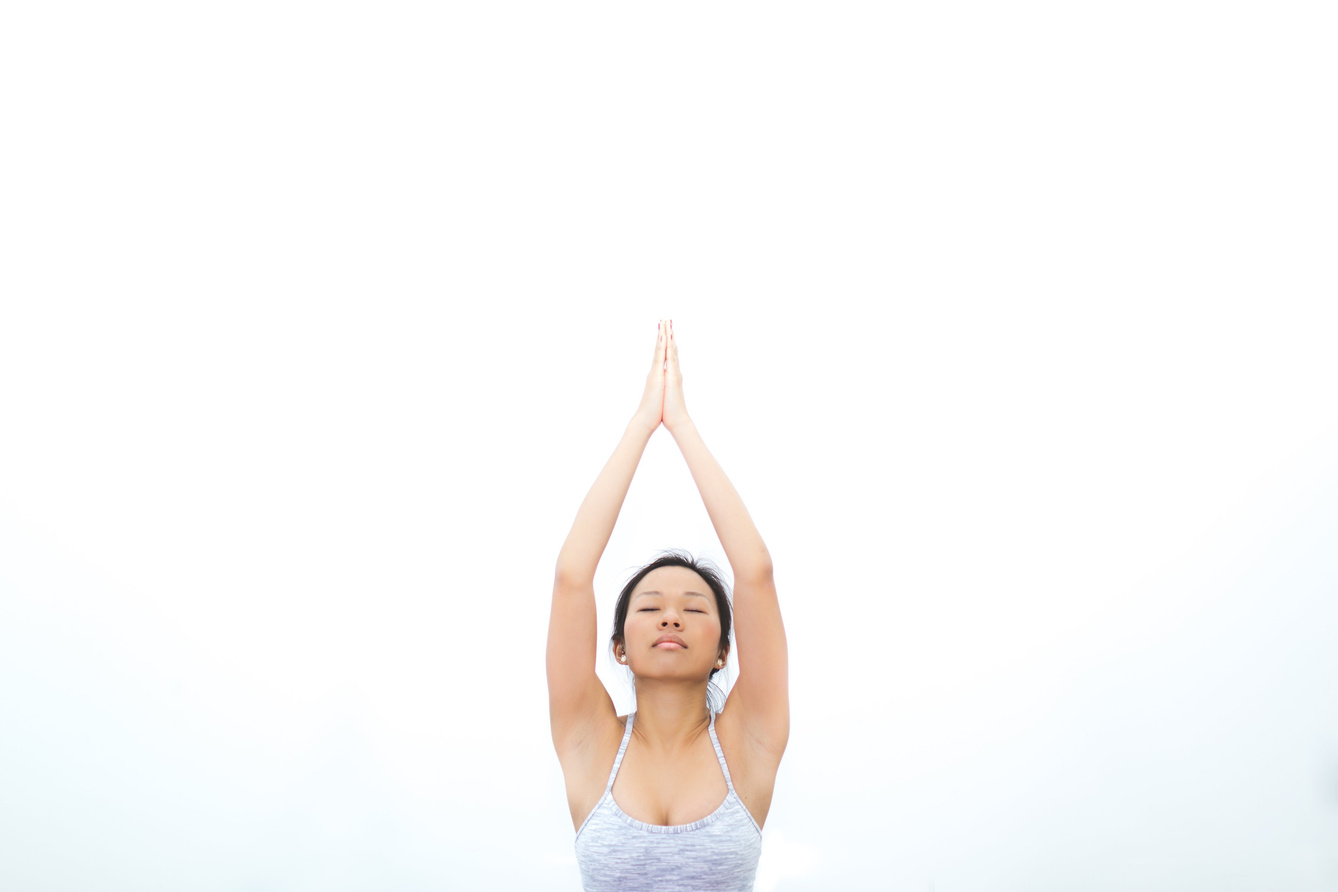 Woman Doing a Yoga Pose on a Mat